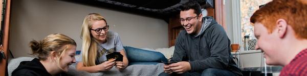 College student playing cards in a dorm room.